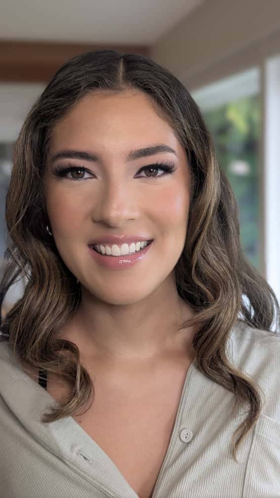 Client in natural soft glam makeup with loose waves, by Eleglam
