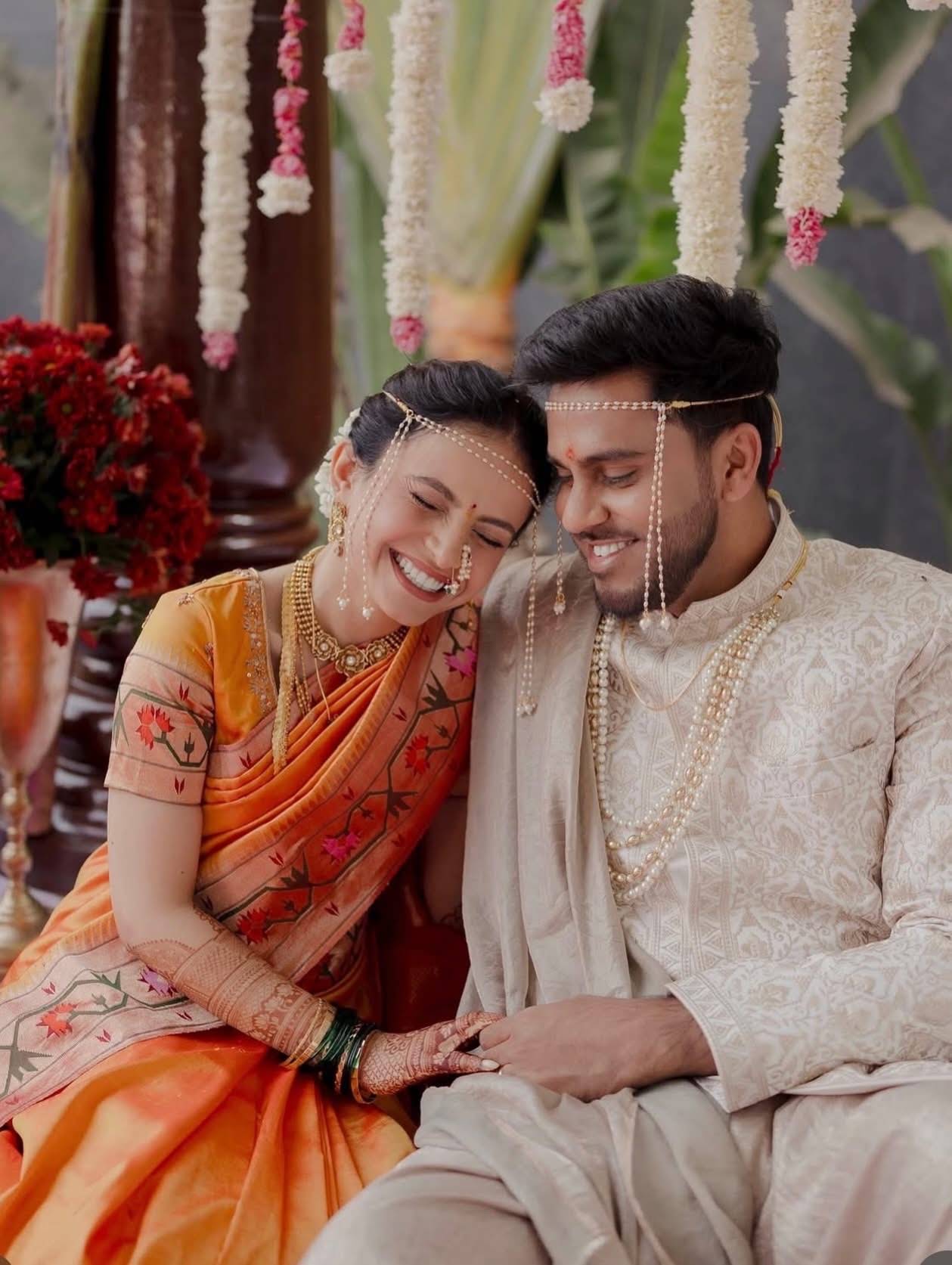 South Asian bride and groom leaning together at their wedding ceremony, bridal glam by Eleglam