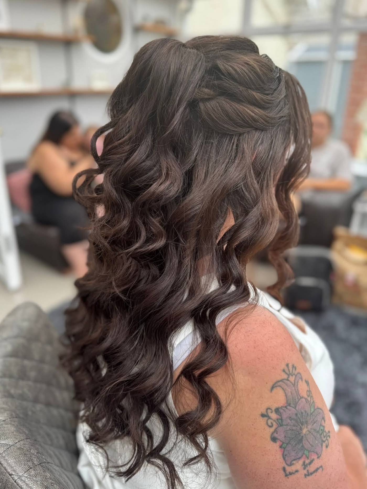 Long cascading half-up curls styled for a wedding reception by Eleglam